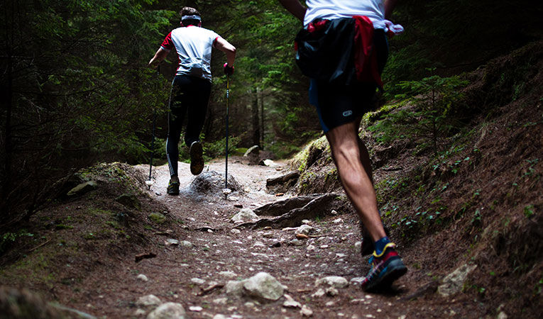 Two men running trails in Romania while studying abroad