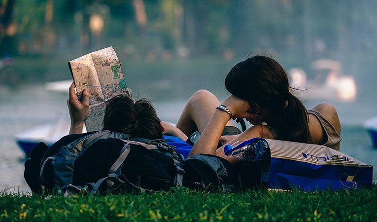 Two backpackers looking at a map