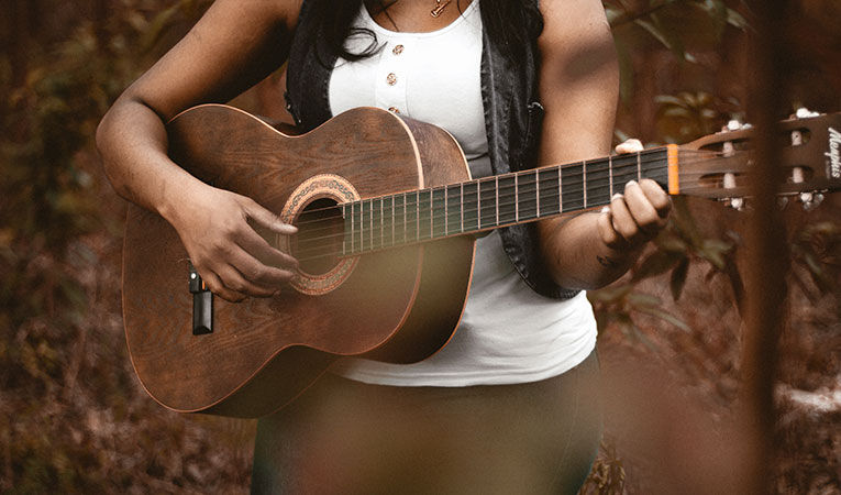 Girl playing guitar at summer language camps in France