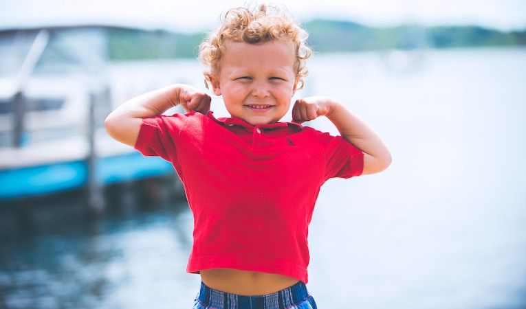 kid flexing arm muscles