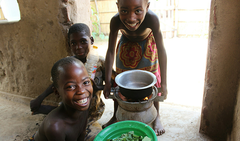 Three smiling African children with supper