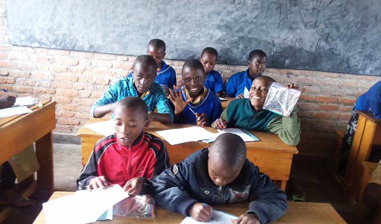 Young African boys sitting in the back of the classroom