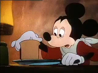 GIF of Mickey mouse cutting a very thin slice of bread