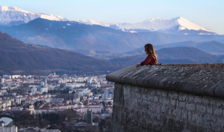 student looking out at Grenoble, France and the mountains 