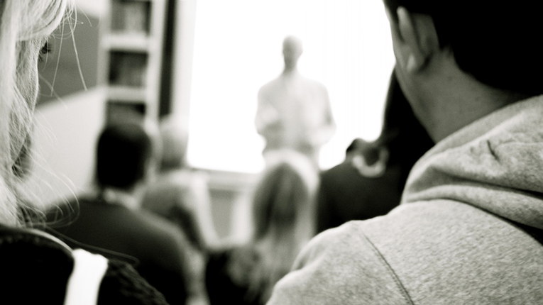Students looking at their professor in a classroom