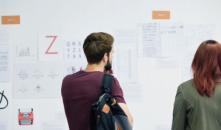 interns in front of bulletin board