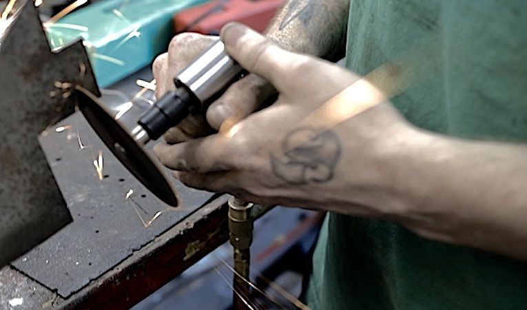 Gap year alumni using a wood-working machine