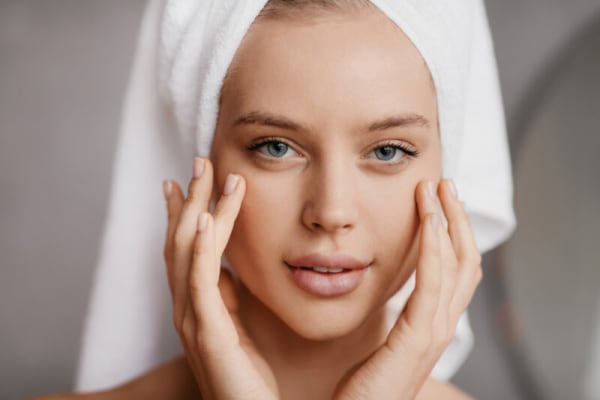 Woman touching bare face