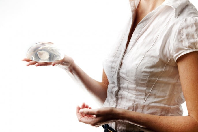 Woman considering breast augmentation options