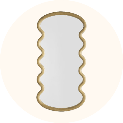 A gold framed wavy edge accent mirror.