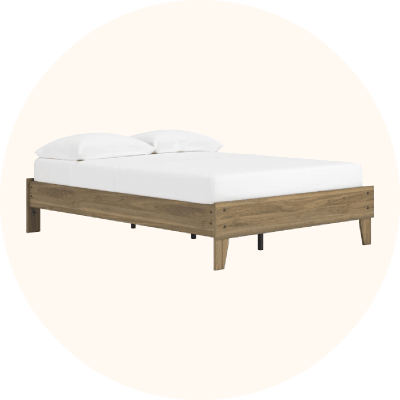A light wood platform bed with a white mattress.