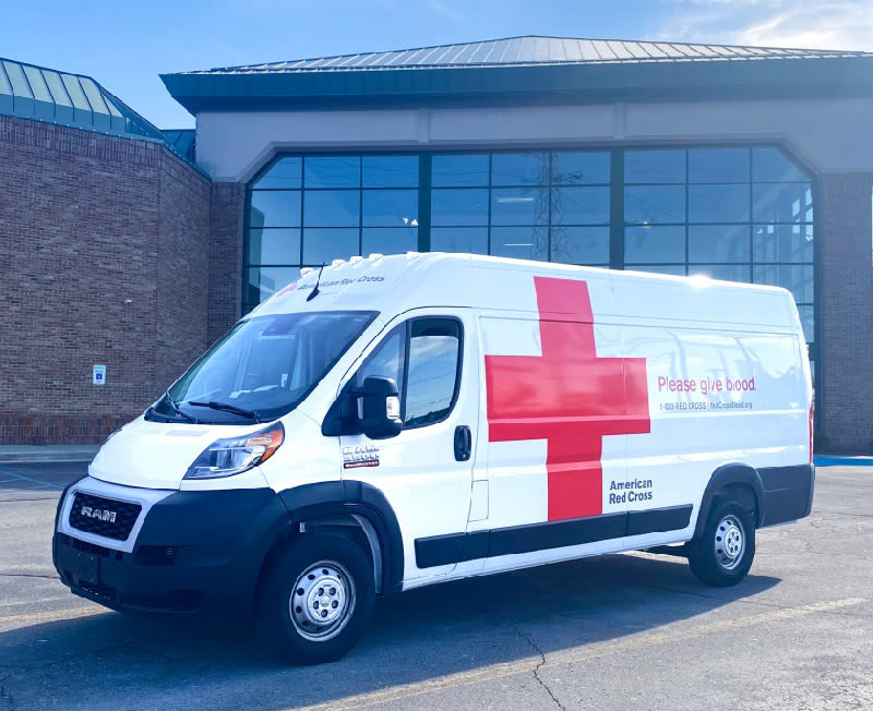 Blood drive vehicle parked in front of a Gardner White store