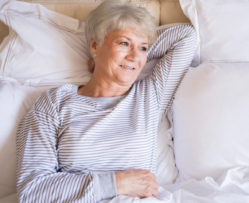 Woman laying on pillows