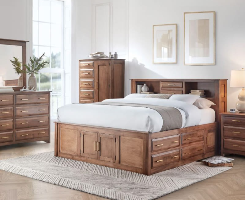 A brown wooden king size bedroom set with a storage bed, a dress & mirror, an armoire, and a nightstand.