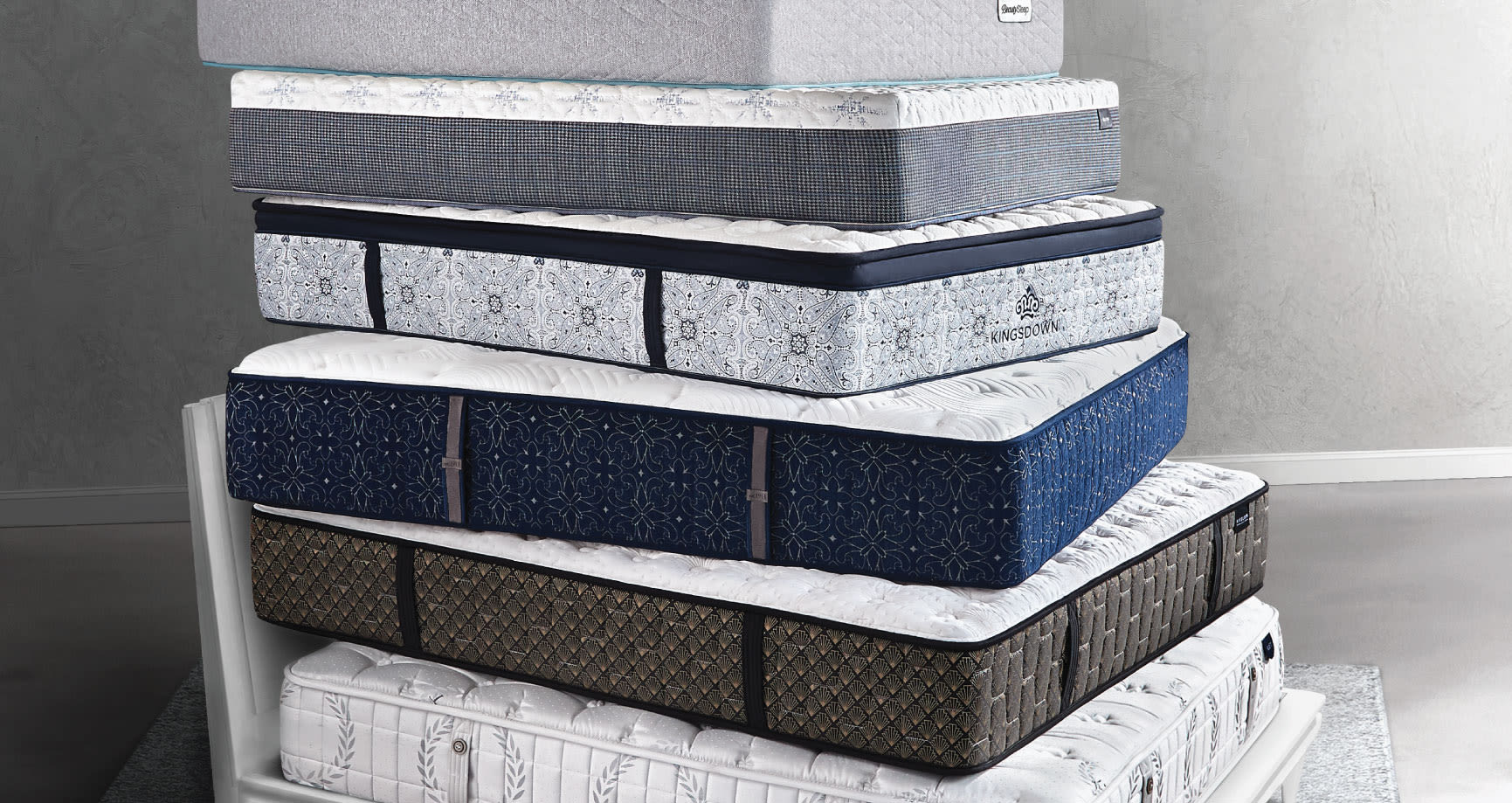 Various mattresses stacked upon each other.