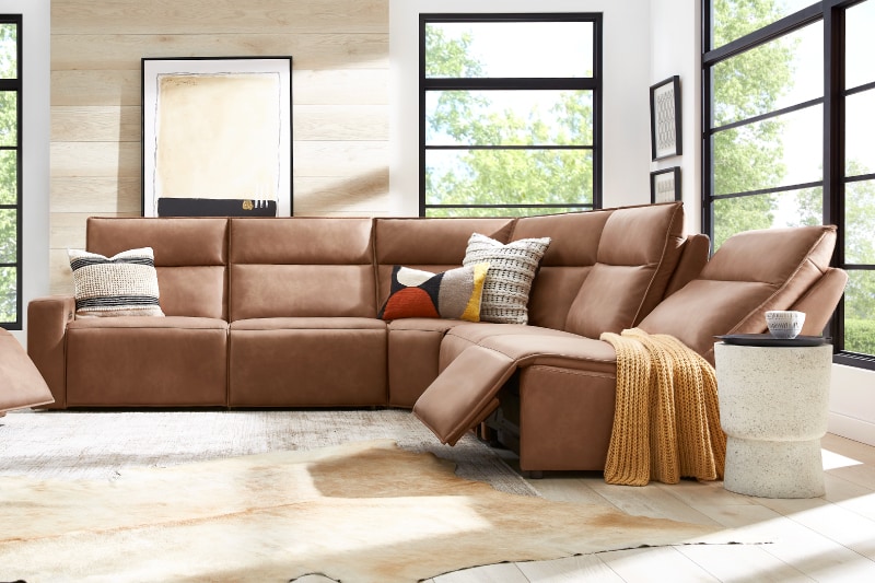 An L-shaped sectional couch in light brown.