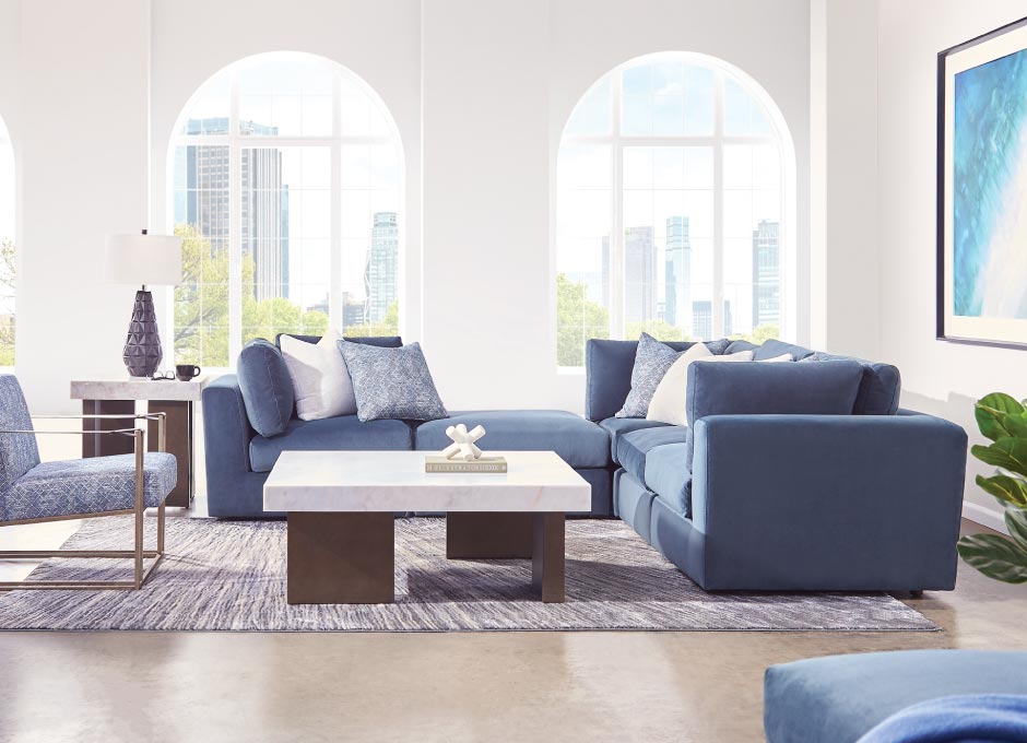 Blue sectional and chair with marbel coffee table