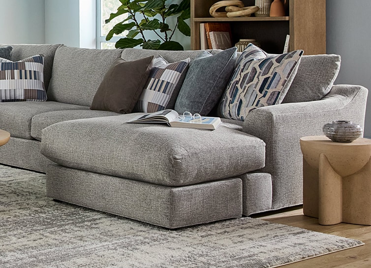 A light gray sectional couch with a right arm facing chaise.