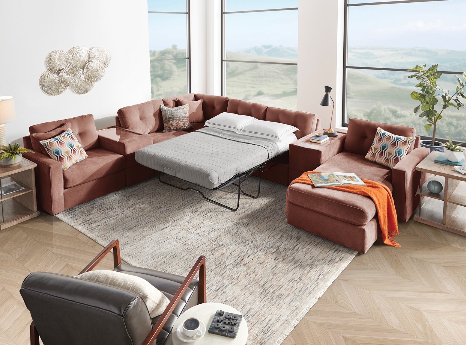 A modular sectional featuring a sleeping sofa inside a living room.