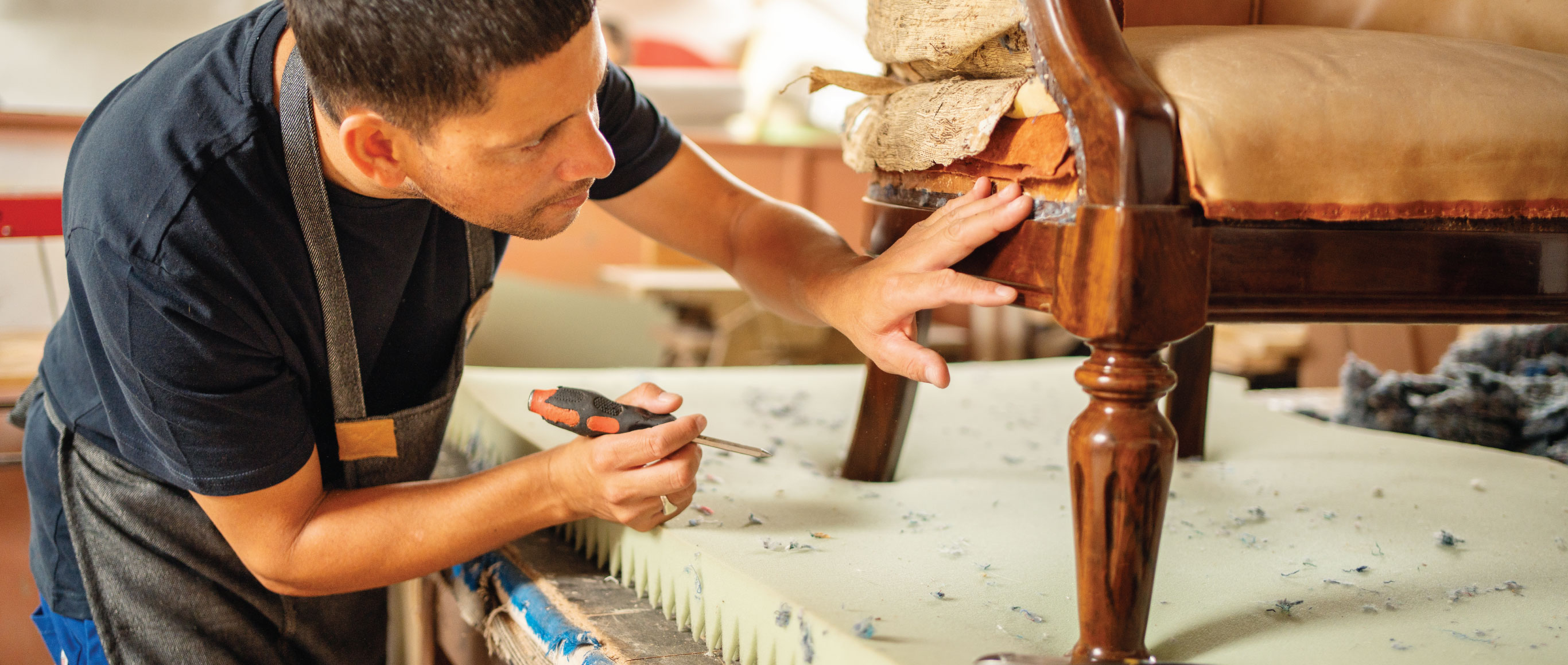 Man repairing a damaged chair.