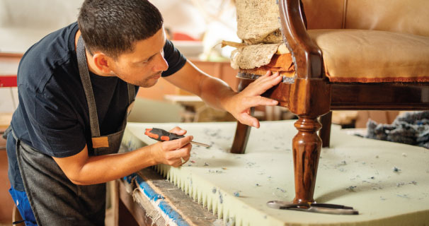Man repairing a damaged chair.