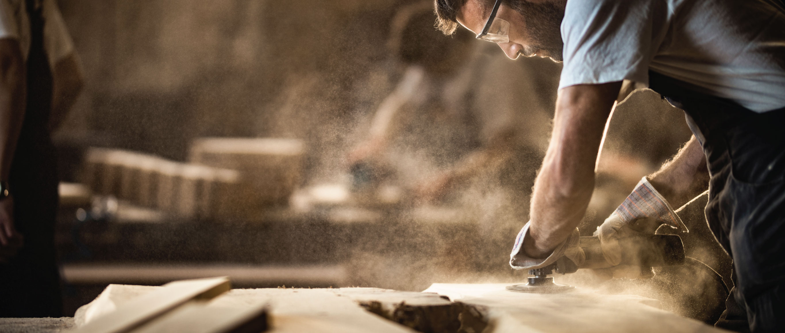 Man in a workshop repairing furniture.