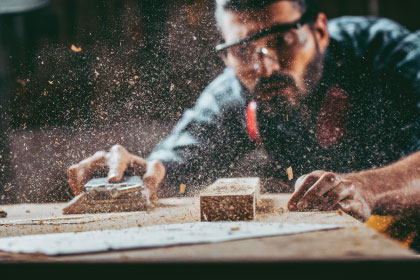 Man repairing a damaged chair.