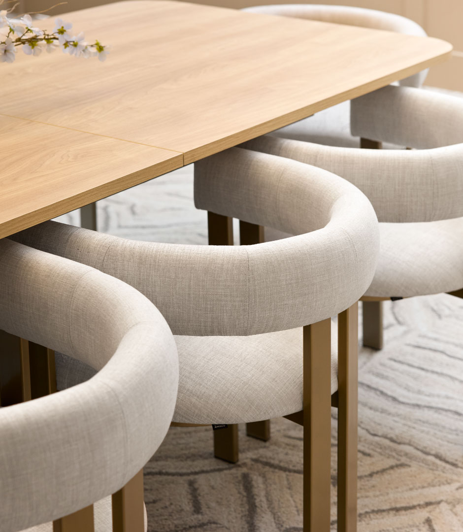 A bright, modern dining nook with curved upholstered banquette seating