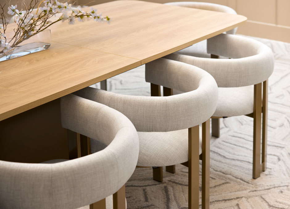 A bright, modern dining nook with curved upholstered banquette seating
