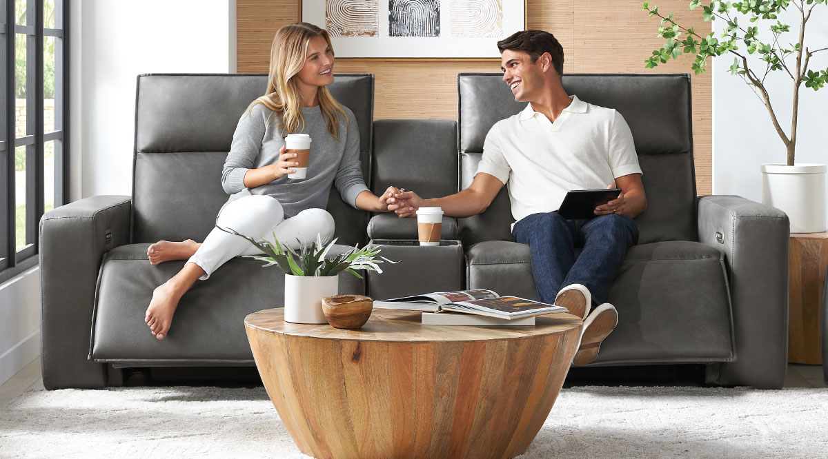 A couple relaxing on reclining chairs.