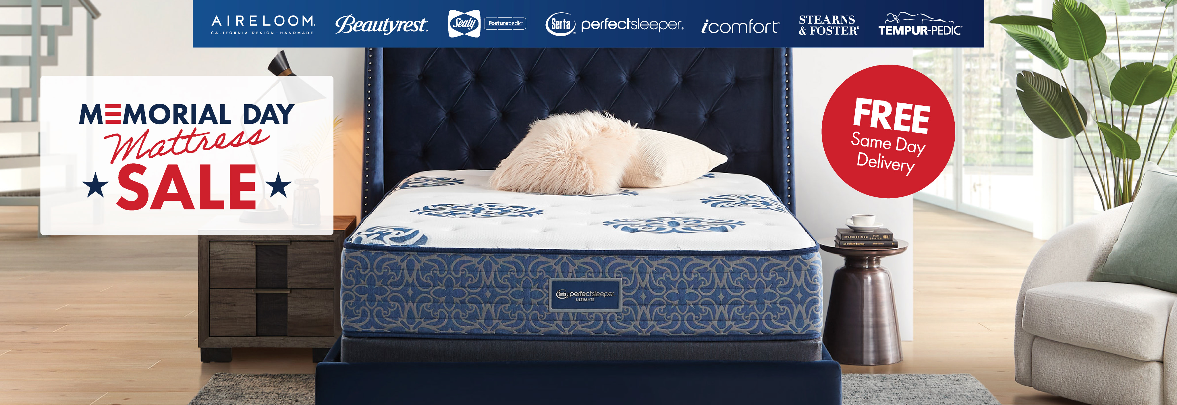 A queen size mattress with a plush blue upholstered headboard in a bedroom.