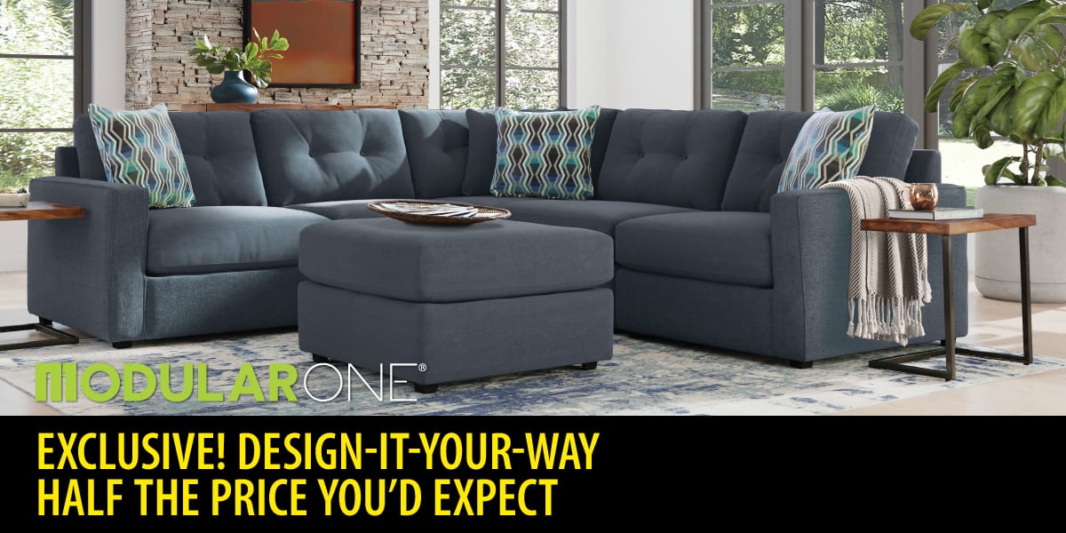 A light blue plush L-shaped modular sectional couch with a matching ottoman.