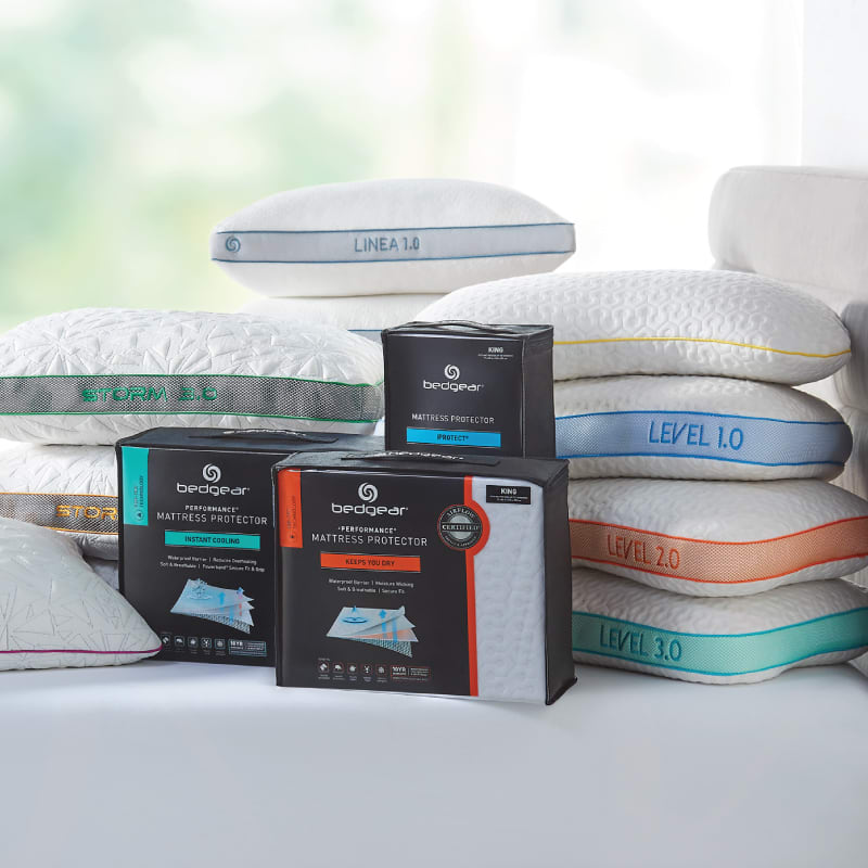 Bedgear pillows and mattress protectors on top of a mattress.