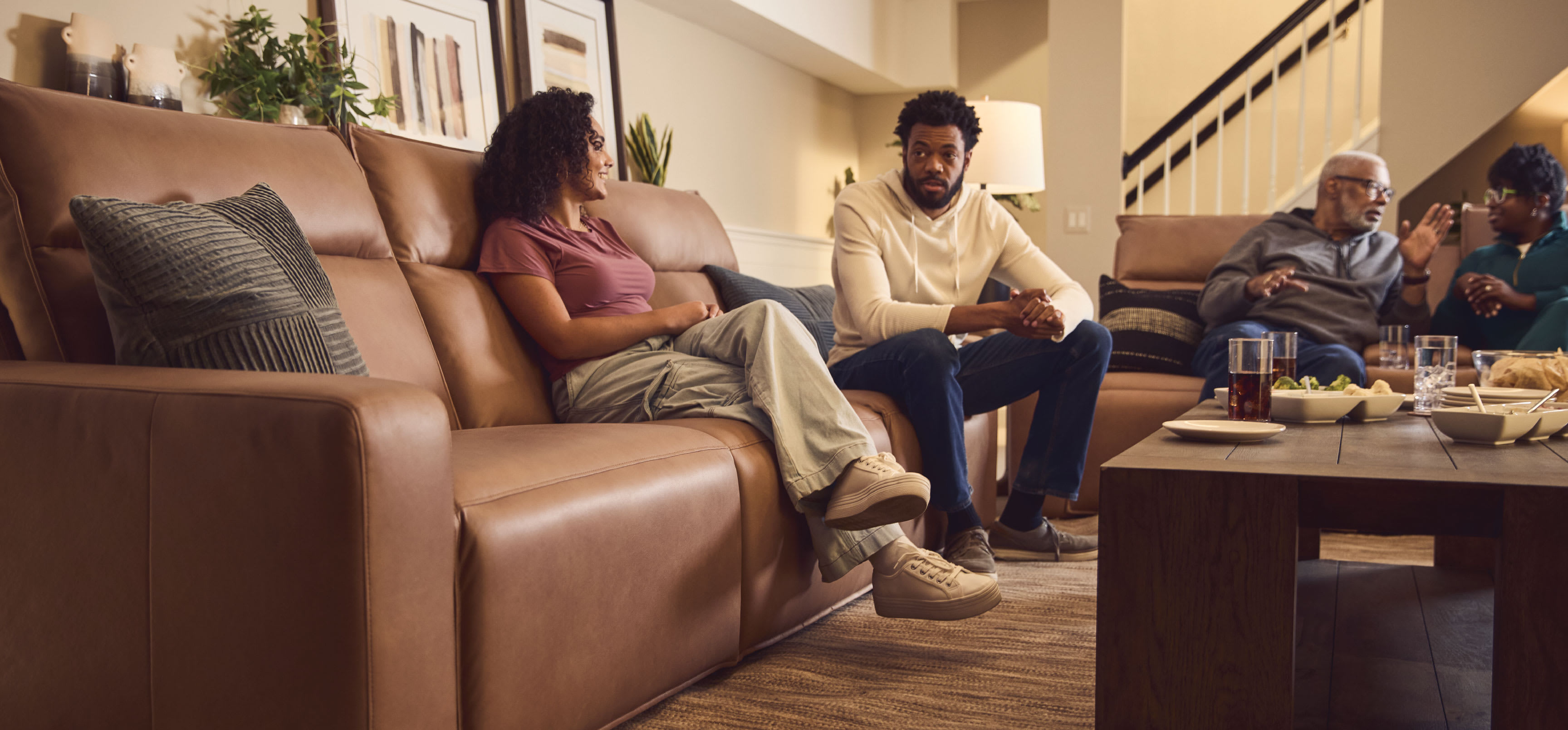 Family sitting on reclining sofas in a living room