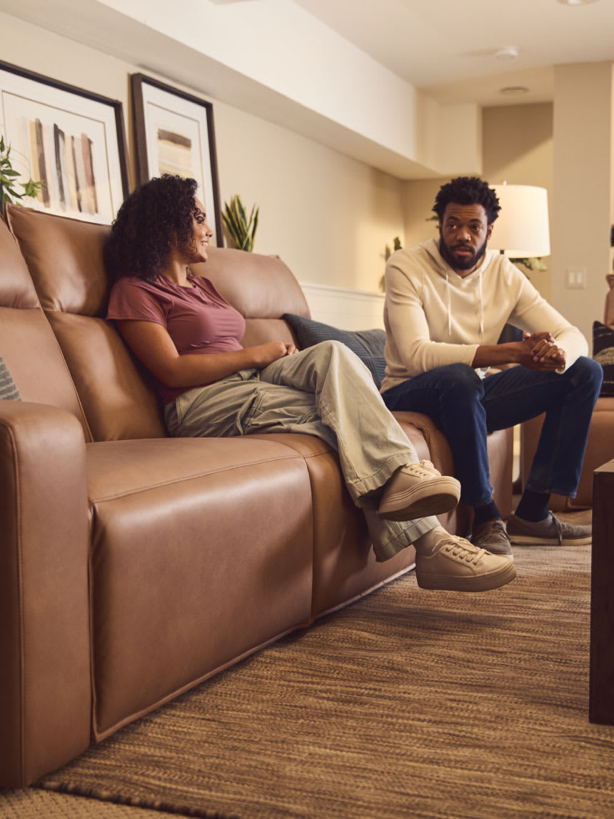 Family sitting on reclining sofas in a living room
