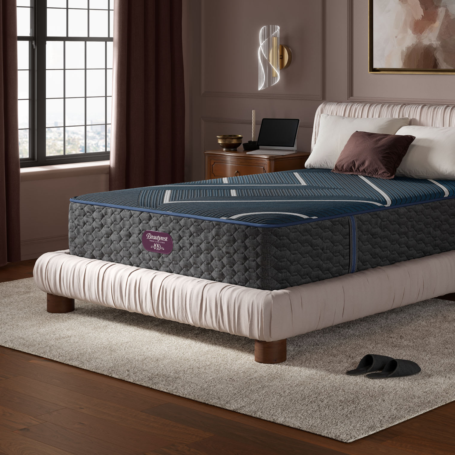 A corner view of a Beautyrest mattress atop a light gray bed. The mattress is a queen size innerspring.