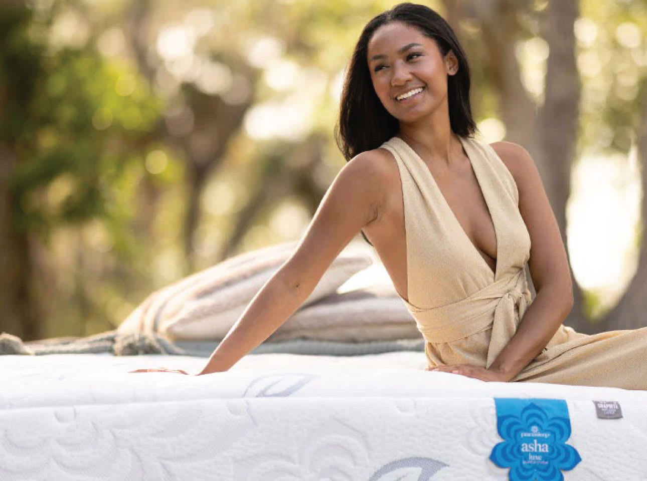 Woman sitting on mattress.