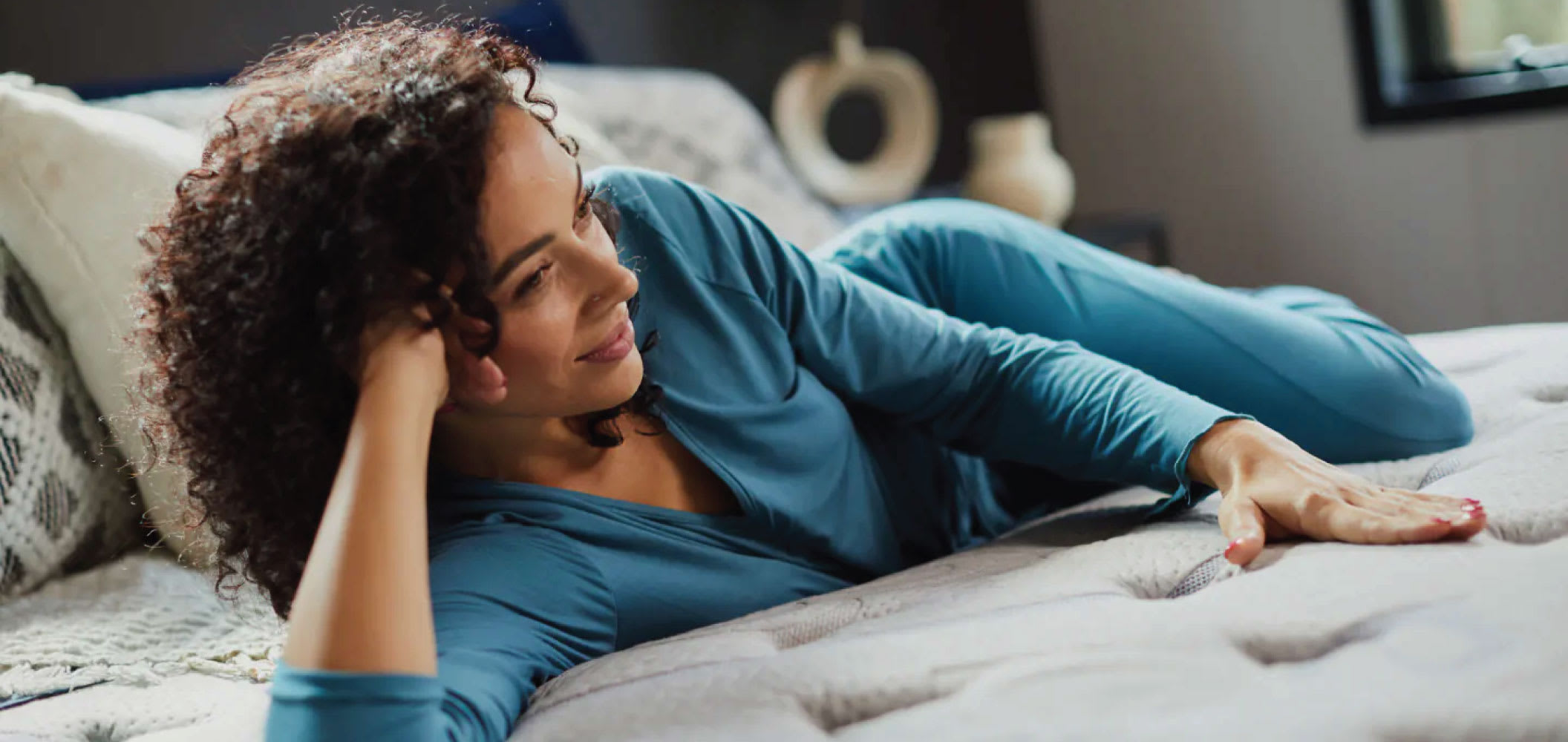Woman relaxing on a PranaSleep mattress.