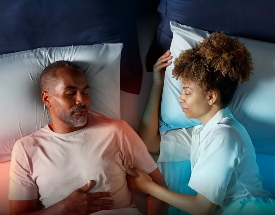 Man and woman laying on a Tempur-Pedic mattress