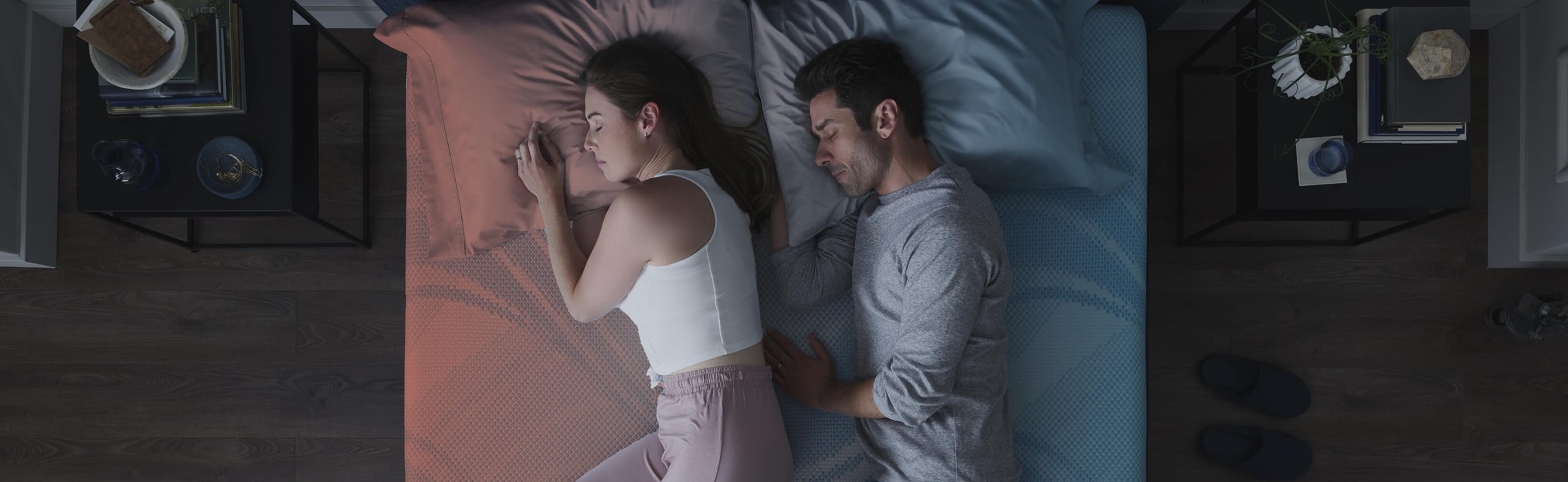 A man and woman sleeping on an ActiveBreeze mattress in a bedroom.