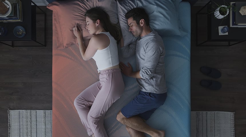 A man and woman sleeping on an ActiveBreeze mattress in a bedroom.