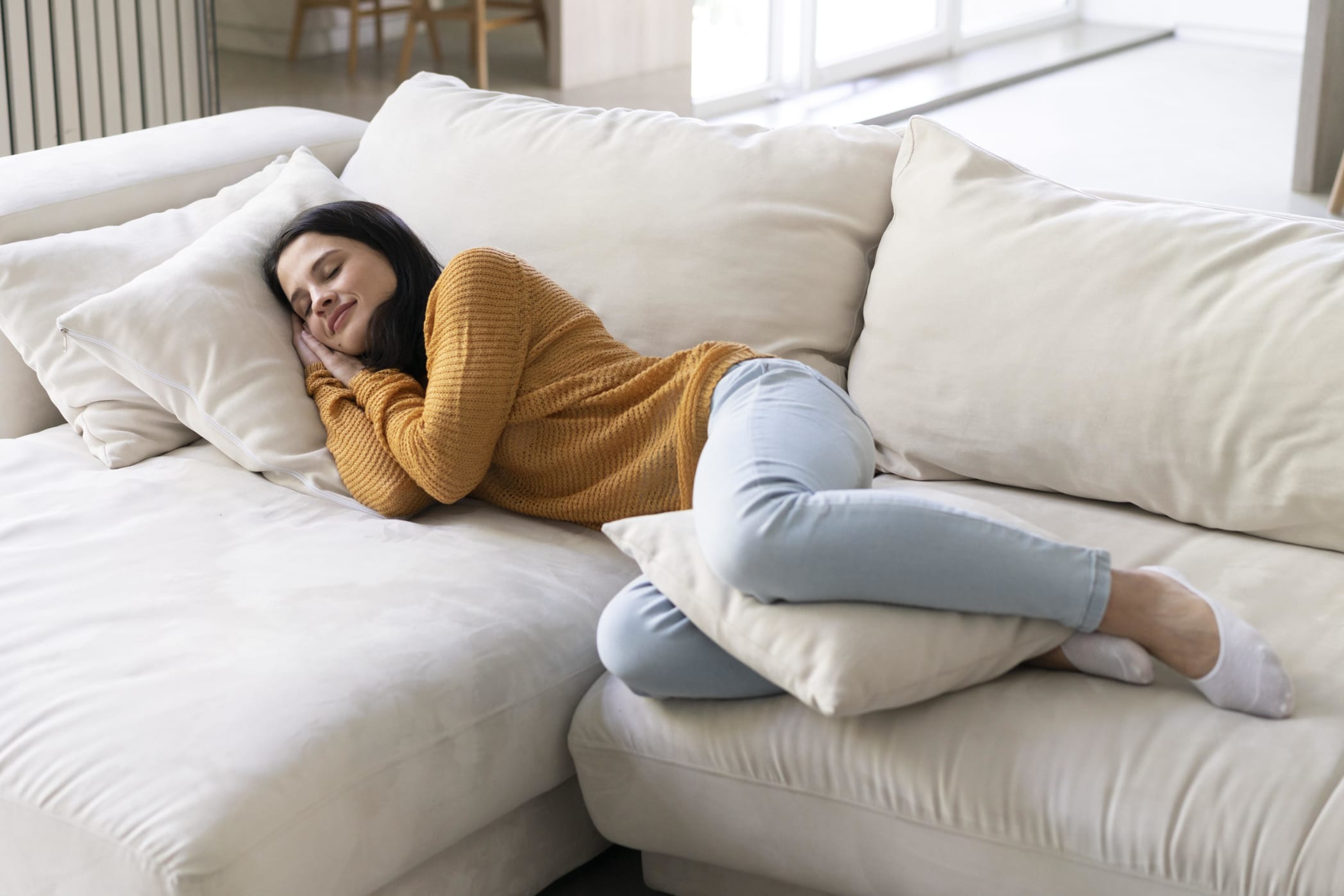 A woman sleeping on a sleeper sectional couch