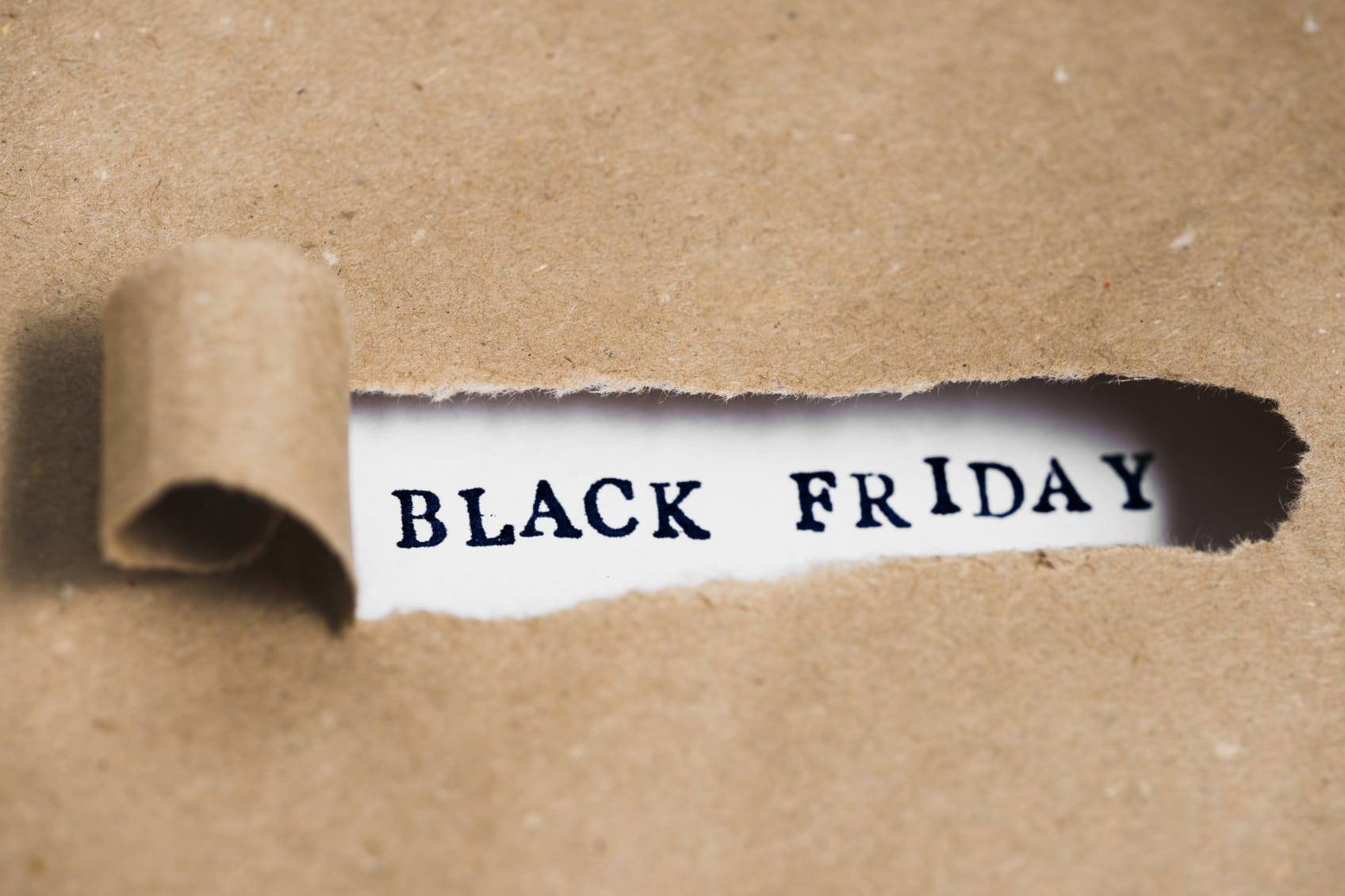 Black Friday typed on paper as seen through a torn paper bag