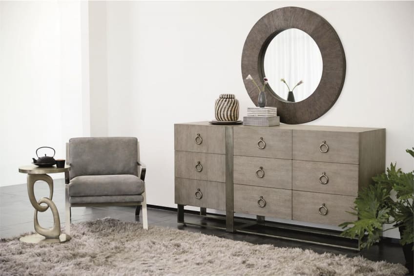 A gray dresser with six drawers and a mirror