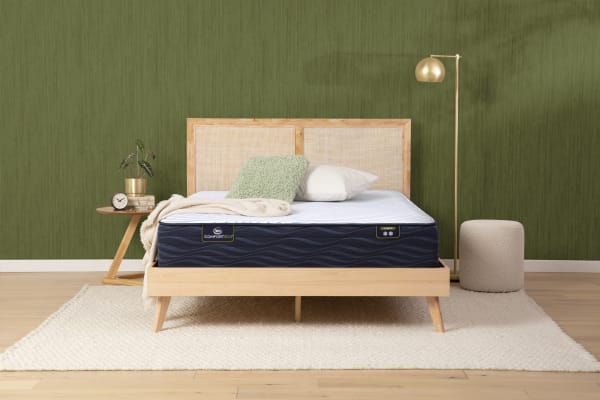 A Serta mattress atop a bed in a bedroom.