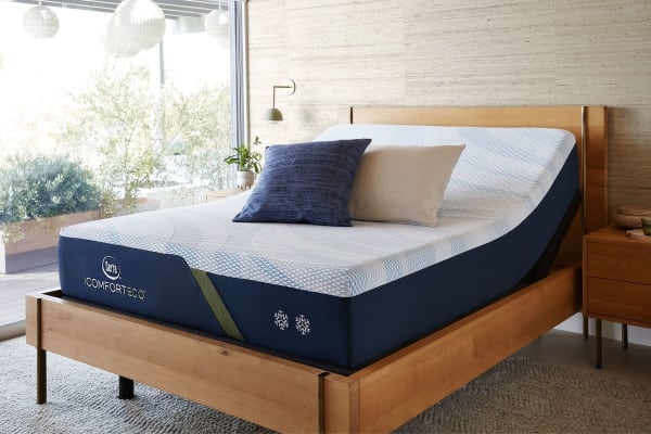 A Serta mattress atop an adjustable base in a bedroom.