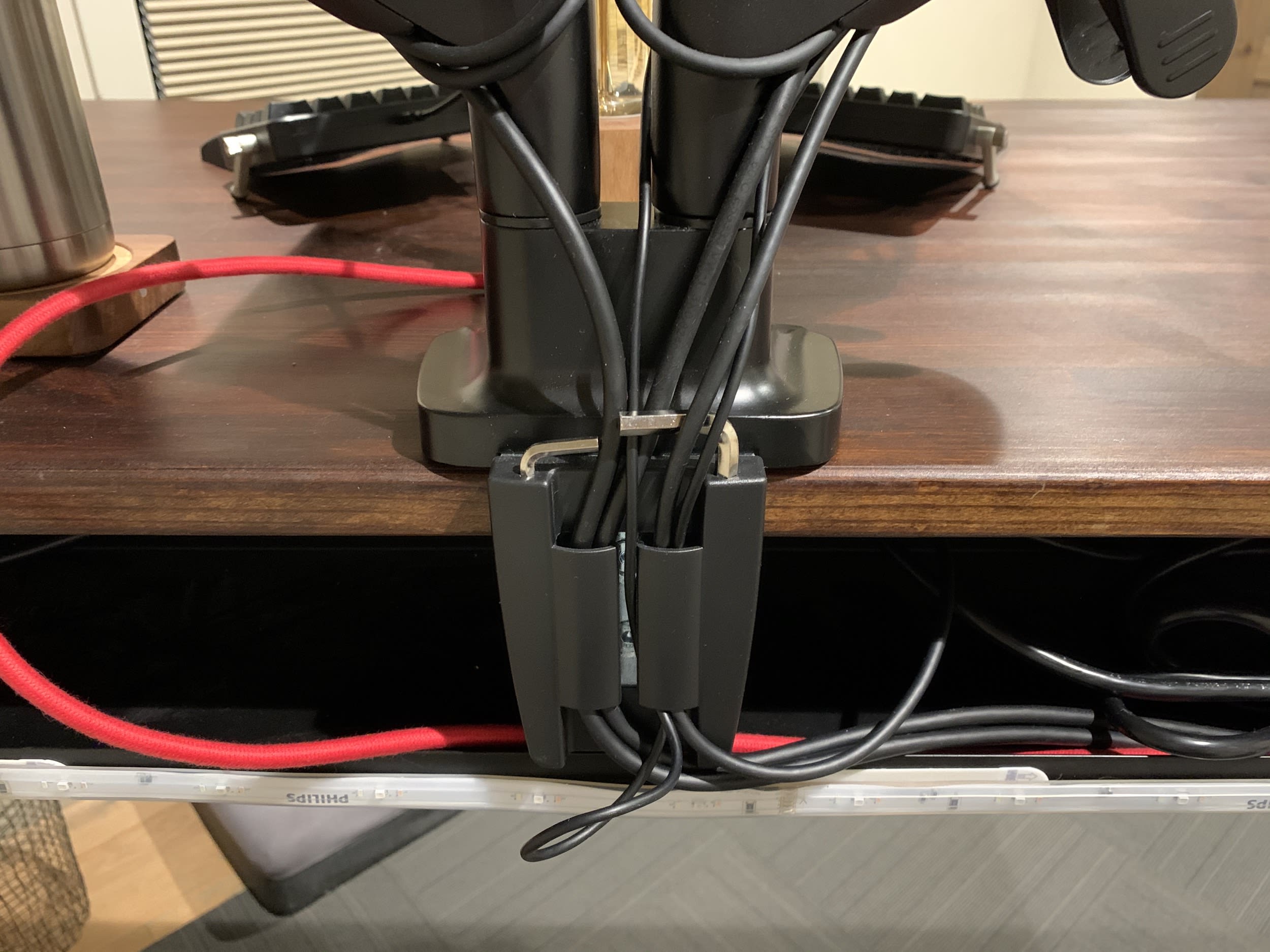 A photo of the Jarvis monitor arm base that provides places to keep cords out of sight.