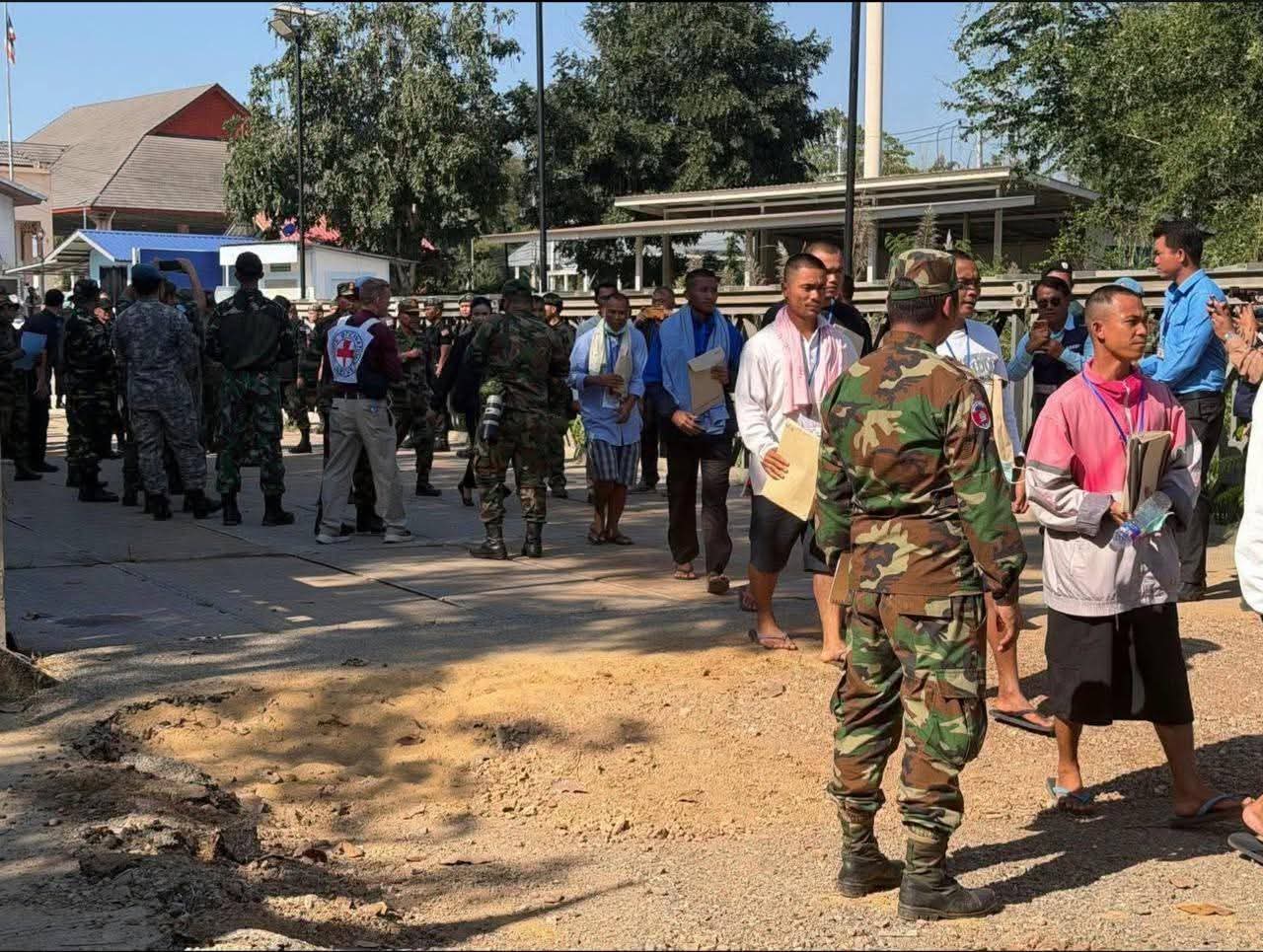 A soldier receiving initial care and a warm welcome from Cambodian officials