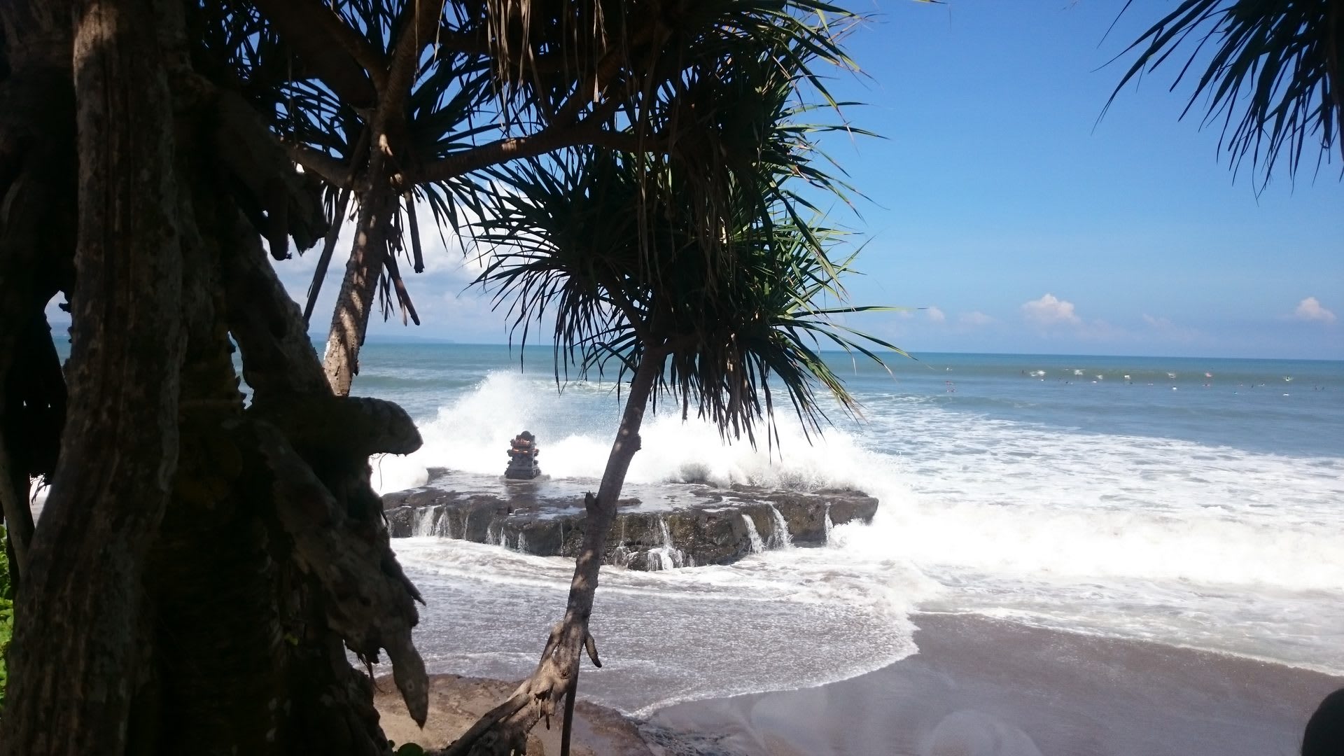 Waves breaking over the rocky point at Batu Bolong, Canggu
