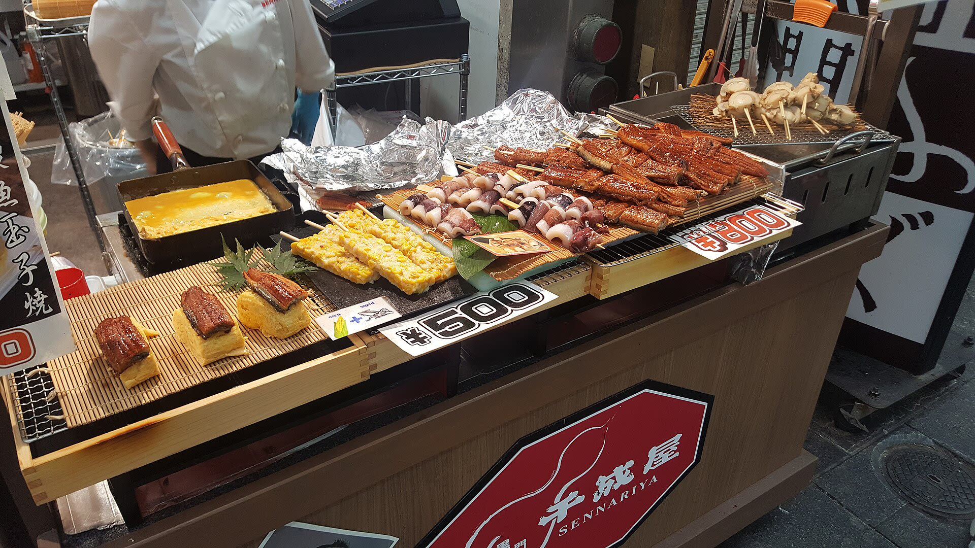 Fresh seafood displayed at a stall inside Kuromon Market in Osaka